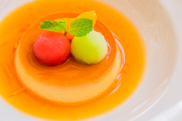 Caramel custard pudding in white plate.