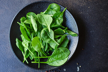 spinach salad green juicy leaves organic salad serving size natural top view copy space  for text diet raw food background rustic