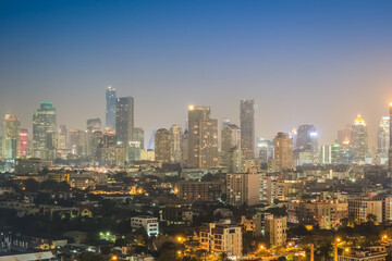 Fototapeta na wymiar Aerial view of the modern buildings and skyscrapers at night of Bangkok City, Thailand.