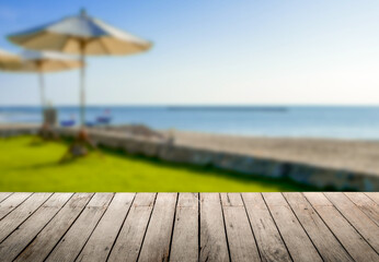 Plakat Image of rustic wood table in front of beautiful beach resort blurred background. Brown wooden empty counter in front of the sea and outdoor spa.