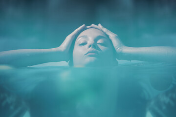 Natural Beauty Of Beautiful Girl In Pool. Model Relaxing In Water At SPA Resort.