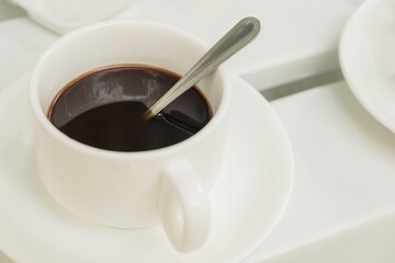 Cup of coffee on wooden table at coffee shop. Hot espresso the best start to any morning at cafe with copy space.