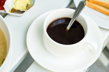 Cup of coffee on wooden table at coffee shop. Hot espresso the best start to any morning at cafe with copy space.