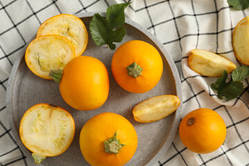 Tray with round zucchini on napkin background
