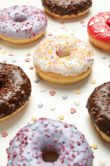 Flat lay with tasty donuts on white background