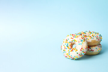 Tasty donuts on two tone background, space for text