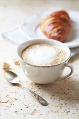 Coffee with milk on bright stone background. Close up.