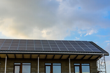 Naklejka premium Solar panels on roof of residential house. Clean energy. Ecological concept