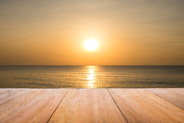 Fototapeta na wymiar Image of rustic wood table in front of beautiful beach background. Brown wooden empty counter in front of the sea and outdoor sunset.