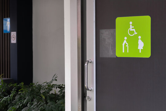 Image of wheelchair or disable person-elderly people-pregnant woman sign or symbol shown on opening slide door of the public toilet background.