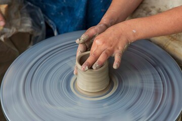 man makes dishes from clay