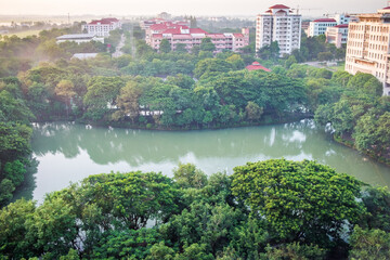 Fototapeta na wymiar The aerial view of lake in green forest during summer day at Nakhon Nayok Province, Thailand.