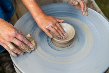 man makes dishes from clay