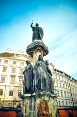 Obraz premium Wien, Austria - sculpture of Austria fountain and flag on Freyung square in Vienna