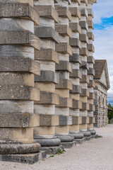 Arc-Et-Senans, France - 08 31 2020: Royal Saltworks of Arc-Et-Senans. Details of alternation of cylindrical and cubic stones on director's house columns