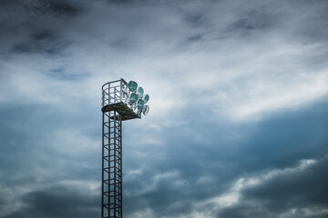 Stadium lights on the cloudy sky background.