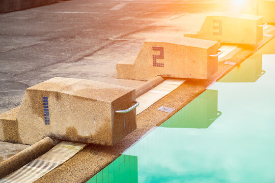 View of starting blocks in swimming pool. This photo can be used for sport concept.