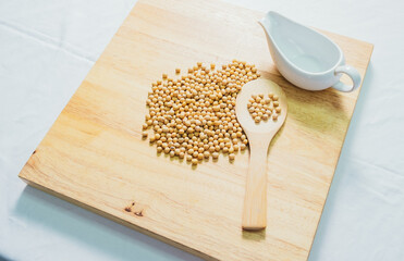 Soy bean in wood spoon on wooden background. Top view