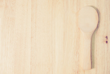 Wooden spoon on rustic wood background. View from above