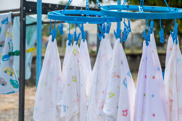 Closeup drying clothes hanging on clothesline at the backyard.