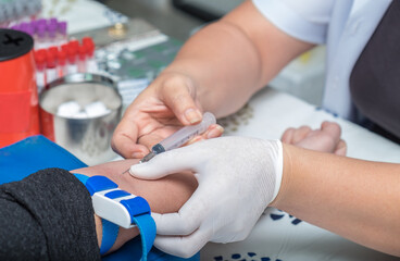 Doctor take needle positive blood sample Coronavirus from the patient in hospital. Nurse mask...