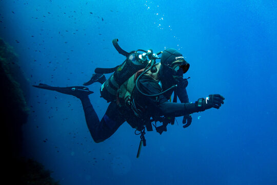 Scuba diver swimming in deep blue