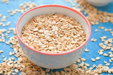 Bowl with raw oatmeal on table