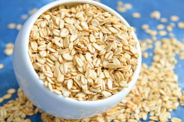 Bowl with raw oatmeal on table