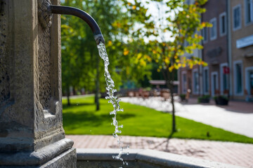 Drinking water fountain in the center of old european town. - obrazy, fototapety, plakaty