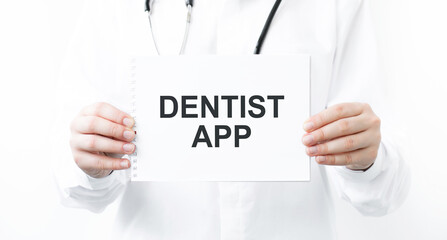 card with DENTIST APP text in the hands of a doctor