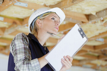 female building inspector holding clipboard