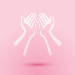 Paper cut Hands icon isolated on pink background. Paper art style. Vector.