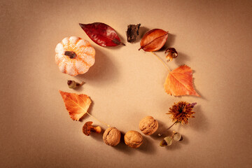 Autumn wreath, shot from the top with a place for text on a brown background