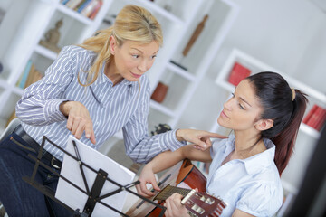 beautiful teenage girl playing an acoustic guitar