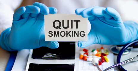 text QUIT SMOKING write on a medicine card. Medical concept