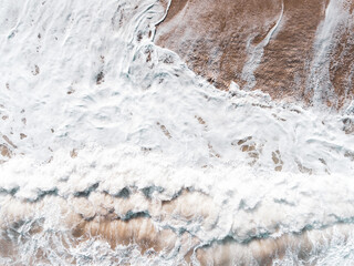 Aerial view of blue sea, waves and beach.