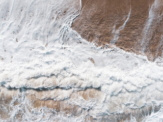 Aerial view of blue sea, waves and beach.
