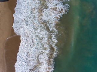 Aerial view of blue sea, waves and beach