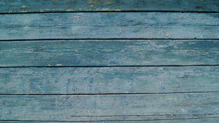 Old wooden planks with cracked paint. Fragment of a wooden wall.