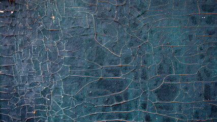 Wood surface with cracked blue paint. Abstract background.