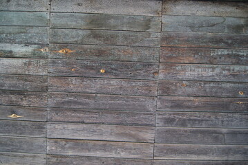 Fototapeta premium Wooden surface made of old unpainted boards. Fragment of a plank wall.