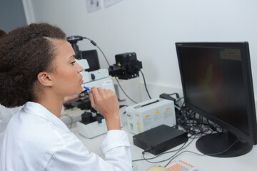 Fototapeta na wymiar Female scientist looking at computer screen