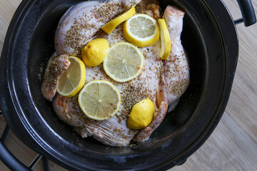 Chicken and lemon slow cooking in a slow cooker.