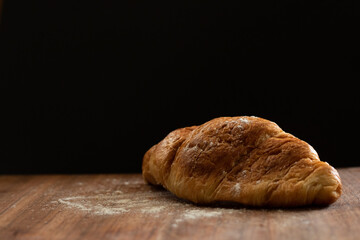 fresh croissant on wooden board