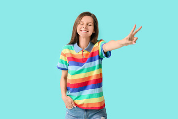 Young woman in rainbow clothes on color background. LGBT concept