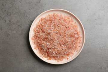 Pink himalayan salt on grey table, top view