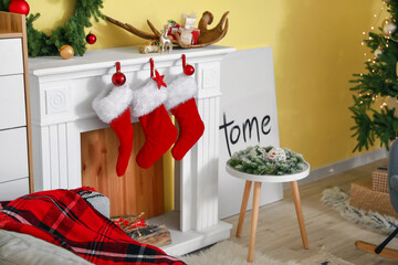 Fireplace with socks in living room decorated for Christmas