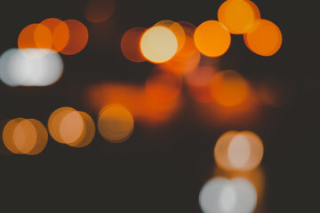 Blurred abstract background of city street lights bokeh illuminated at night.