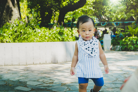 Shot Of Cute Little Asian Baby Boy Walking In Summer Day At The Zoo. Concept Of Extreme Fun And Vacation