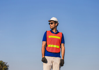 Factory worker man standing on container box and looking to the sky